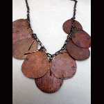 Hammered and fired copper leaves with hammered copper paddles necklace
